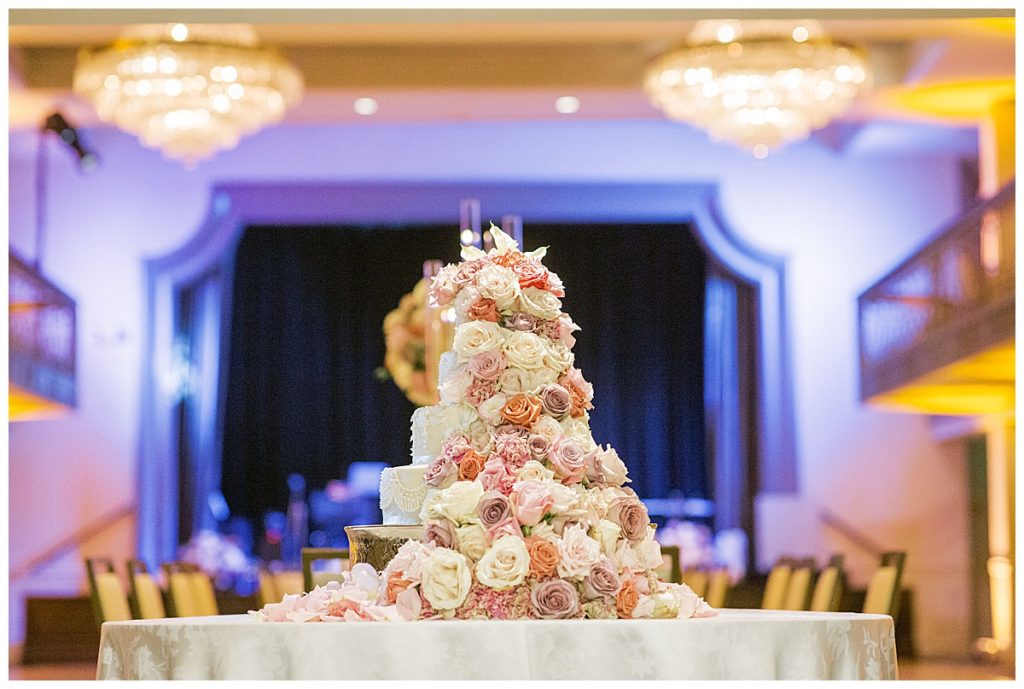 wedding cake covered in flowers at the St. Anthony hotel